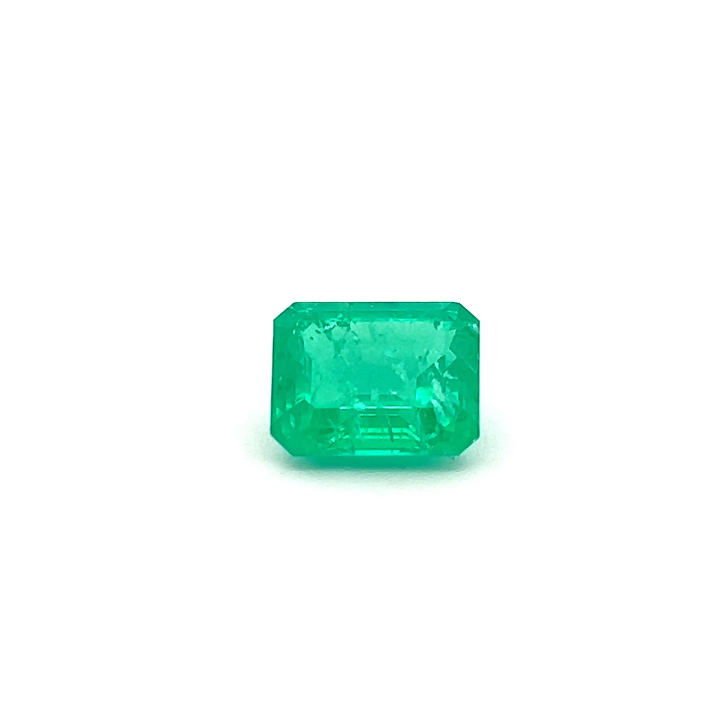 Emerald cut emerald gemstone on a white background