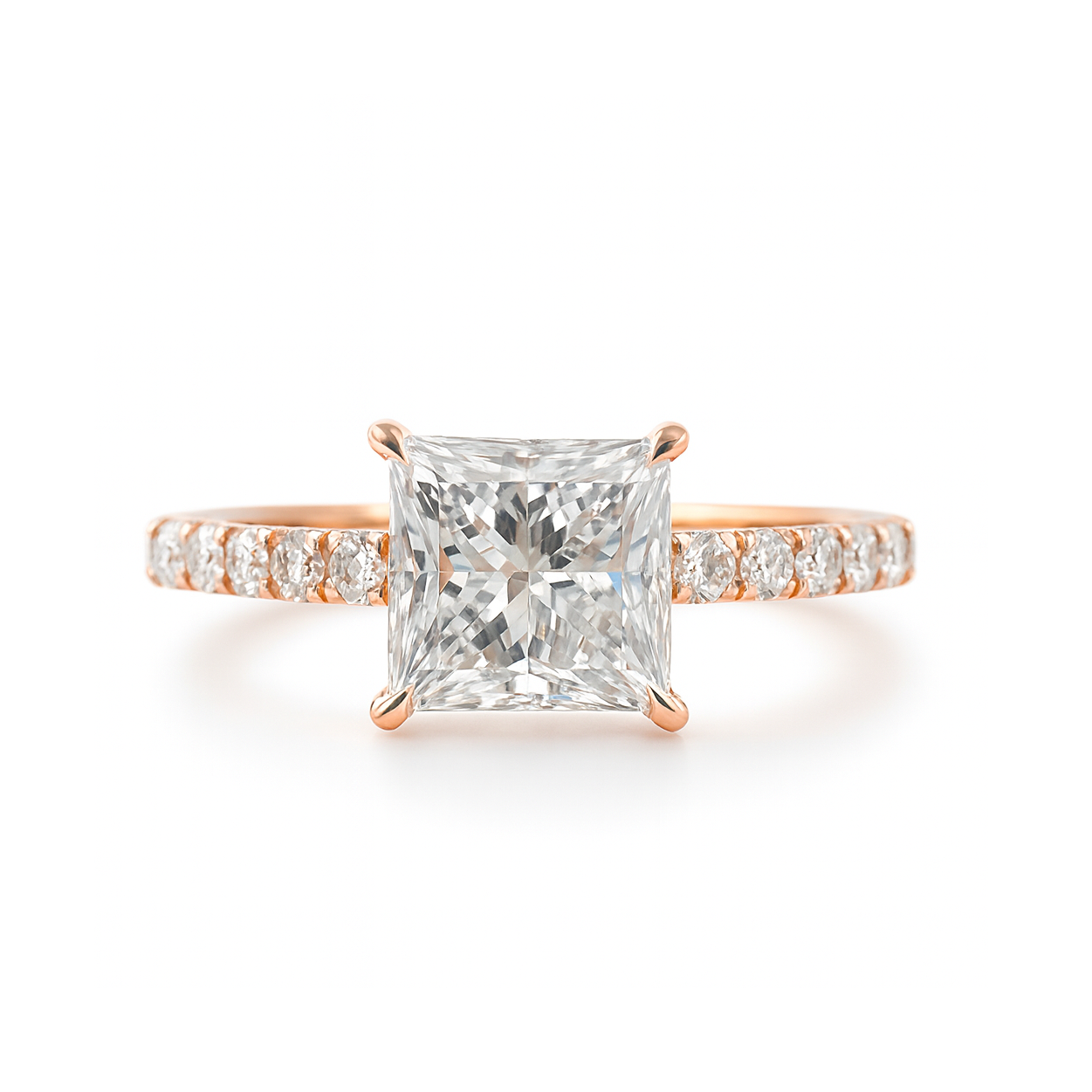 Rose gold ring with a Princess diamond and smaller diamonds on the band against a white background