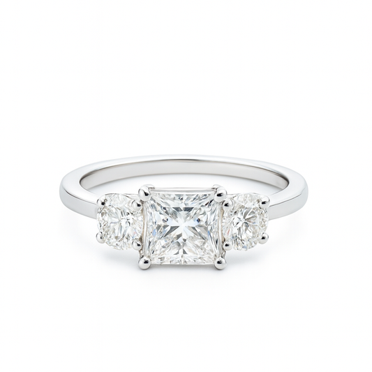 Diamond ring with three clear gemstones on a white background