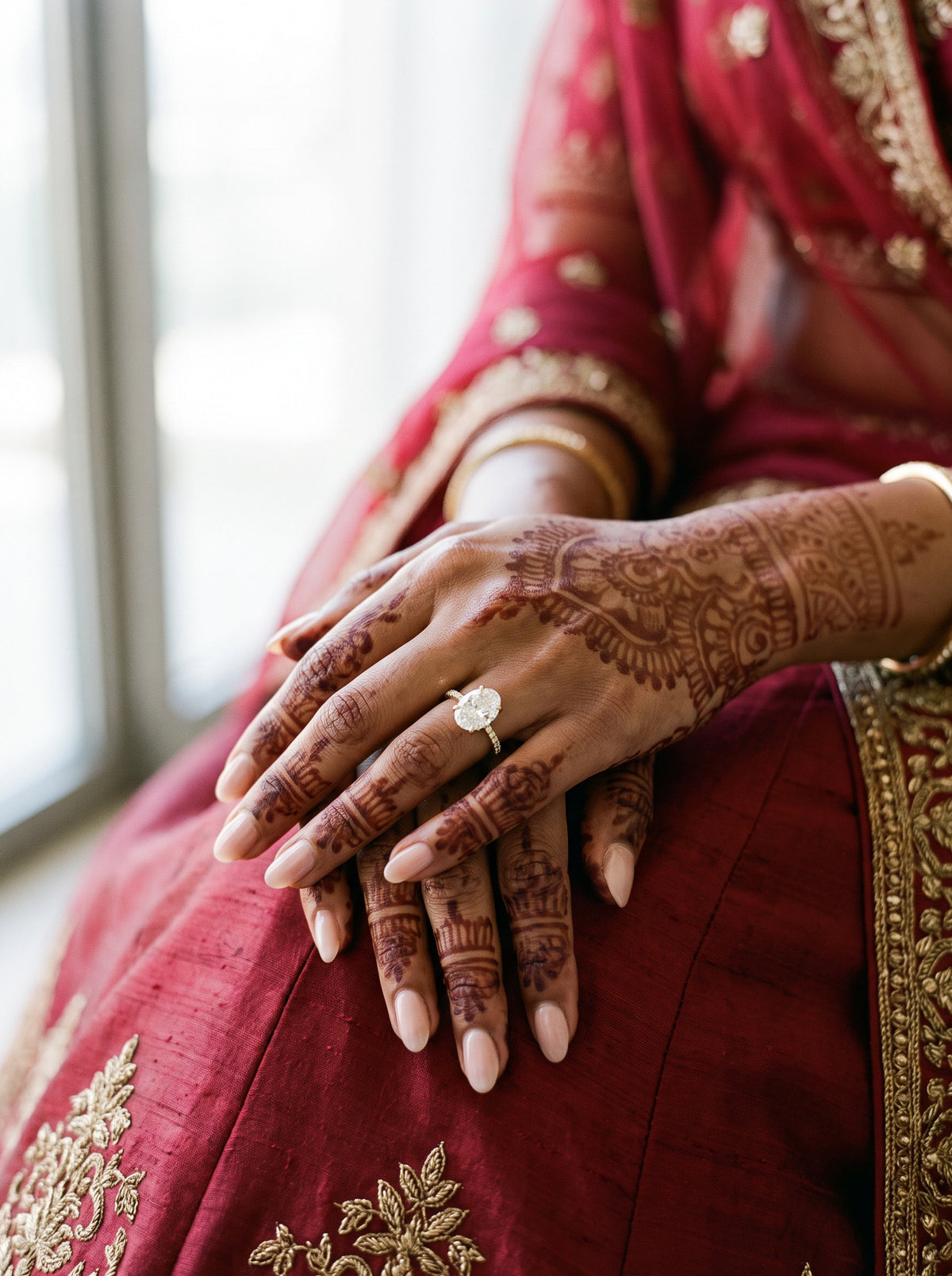 A proposal: a diamond ring on a hand painted with mehendi