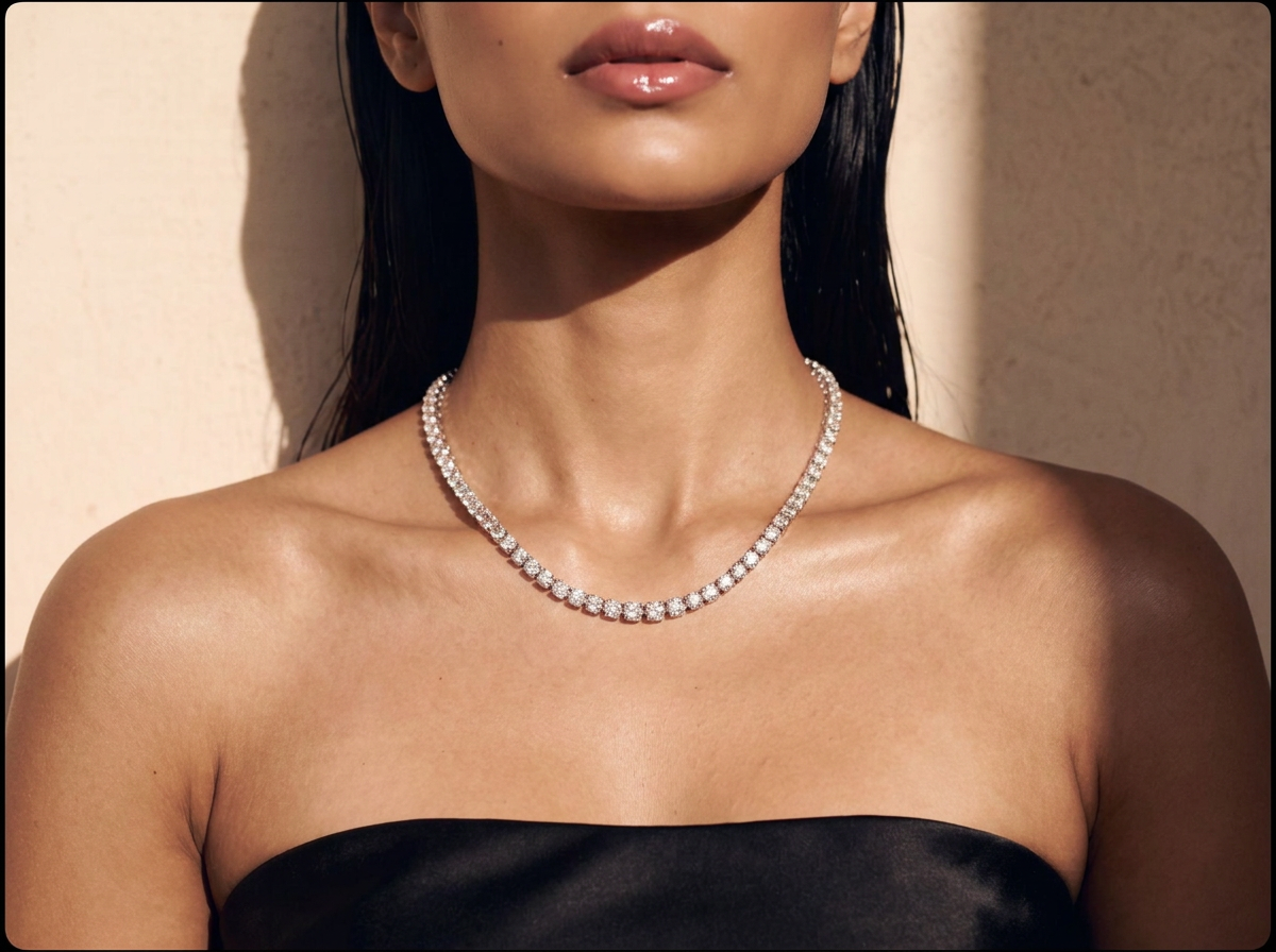 A gold tennis necklace of lab-grown diamonds, close against the skin